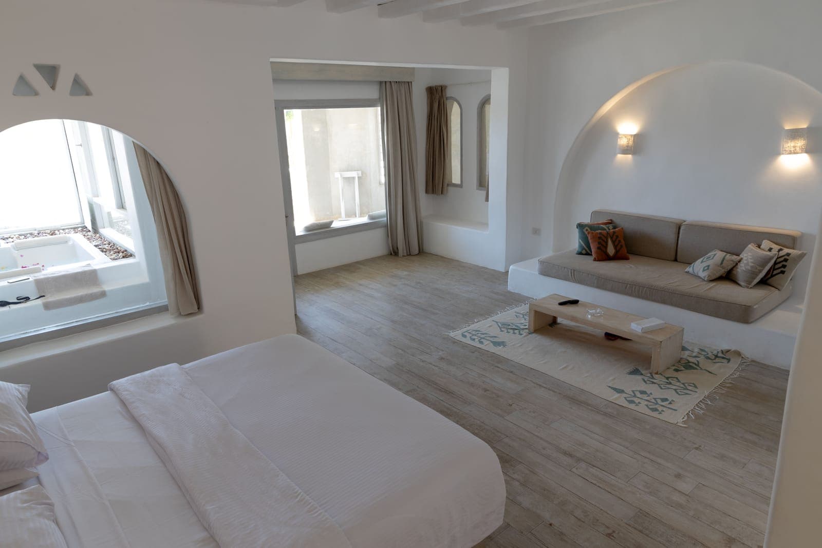 Deluxe Suite bedroom opening into its sitting area and bath space