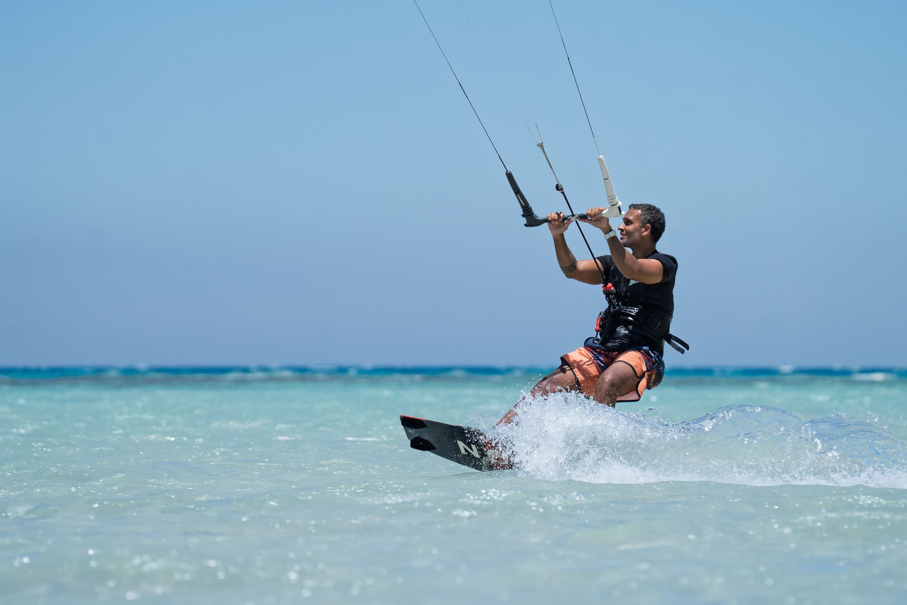 A kitesurfer in action on the turquoise lagoon at Soul, Ras Sudr